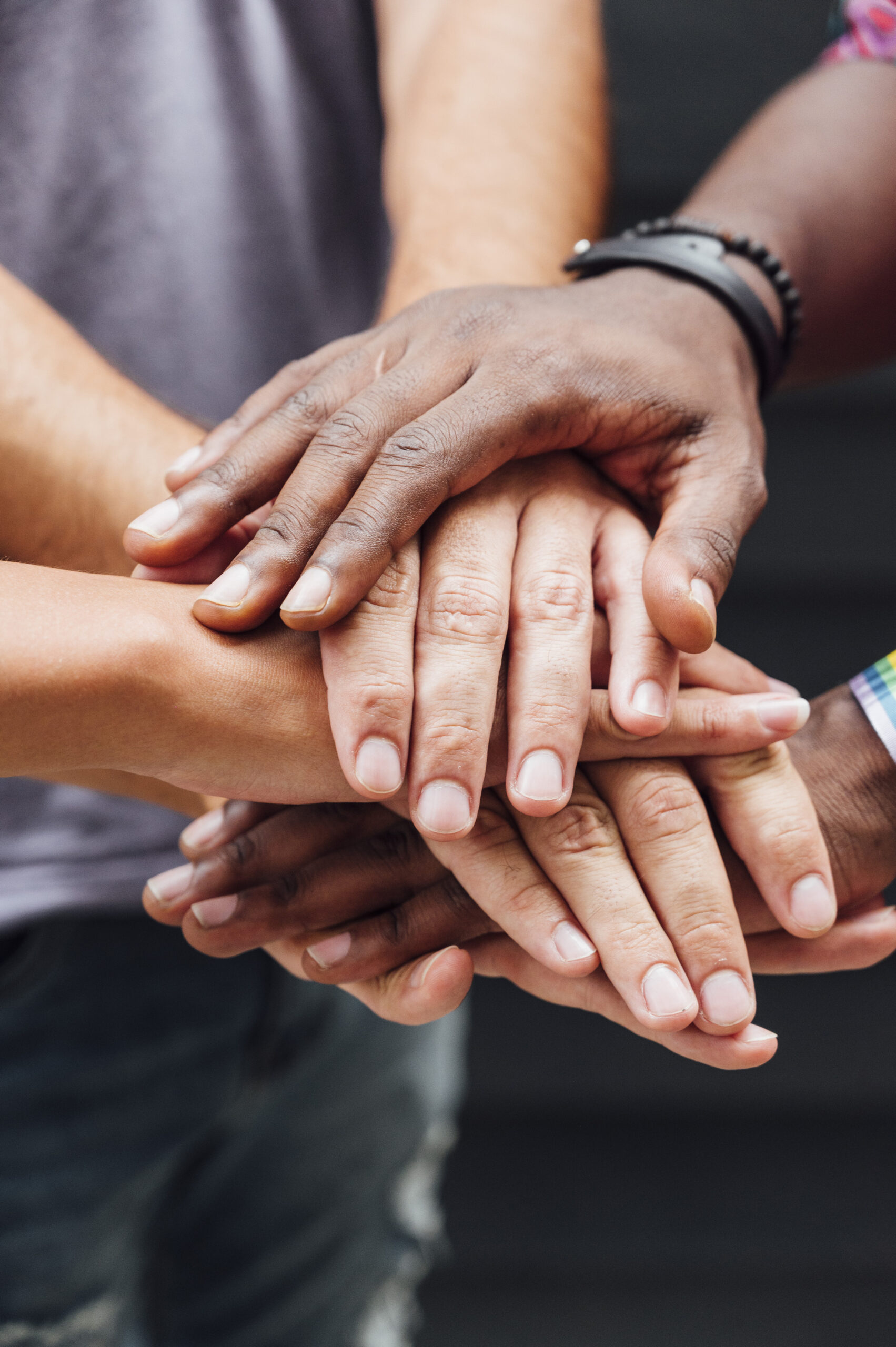 Different people putting hands in stack