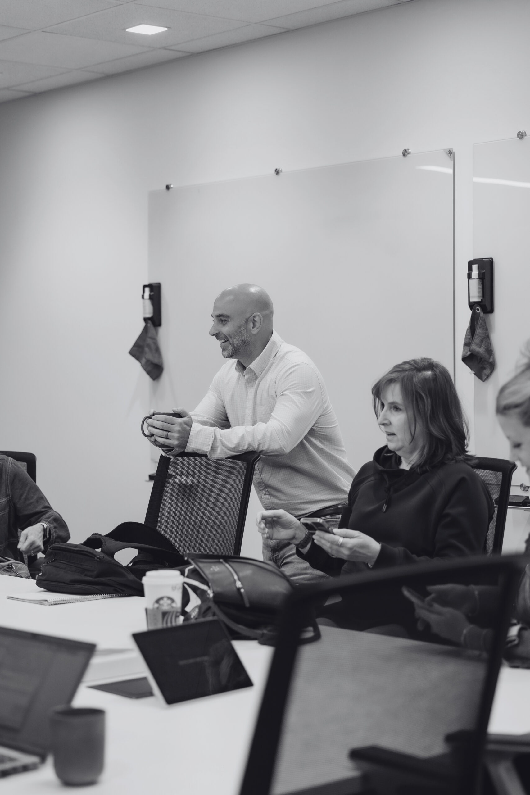 Multiple faces of team members with upward arrow.